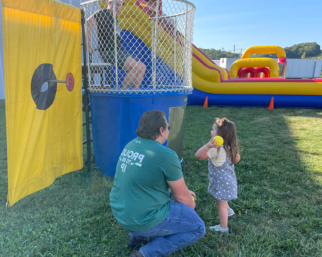 A child throws a ball at a dunk tank on Atglen, PA's Friends & Family Day.